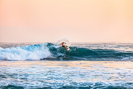 person surfing on ocean waves during daytime