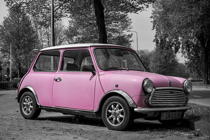 selective color photography of pink 3-door hatchback