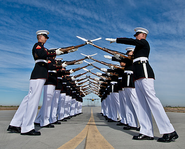 cadets forming two lines while their rifle crossed creating a dome pathway on airport photo