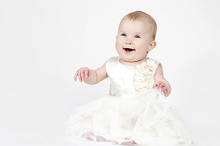baby wearing white crew-neck sleeveless mini dress