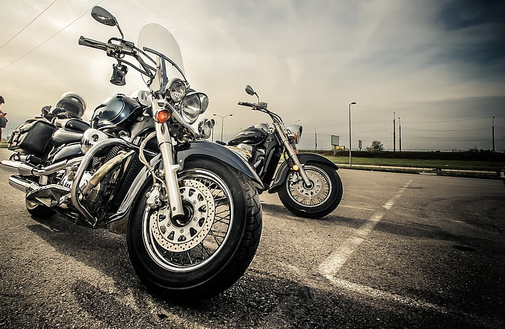 photo of black chopper motorcycle beside motorcycle