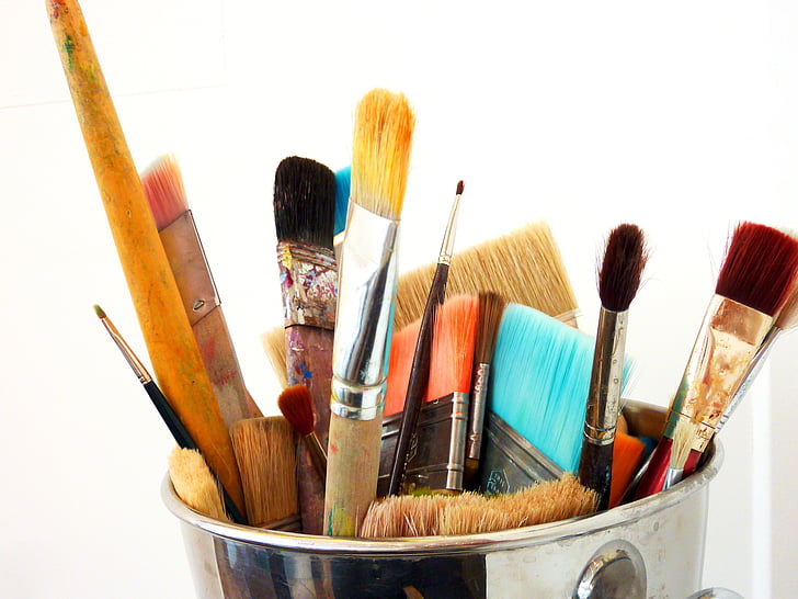 assorted brushes on stainless steel bucket