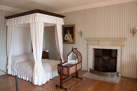 bassinet between canopy bed and fire place