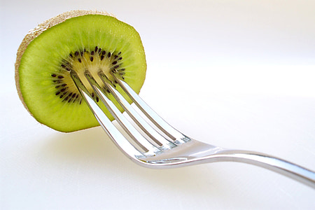 stainless steel fork with sliced kiwi fruit