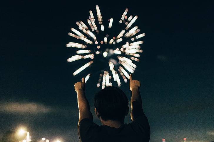 person pointing fireworks