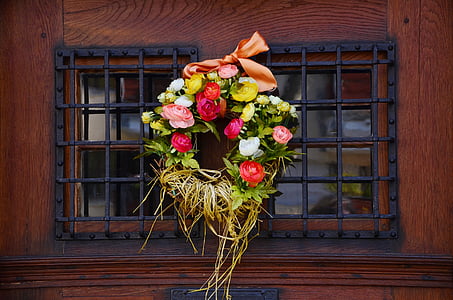 pink and yellow floral wreath hanged on window