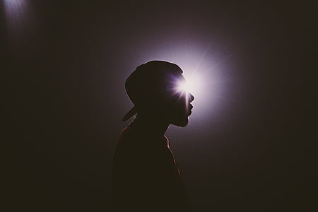 silhouette photo of man wearing hat