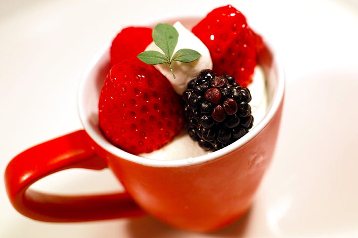 red ceramic cup with strawberries