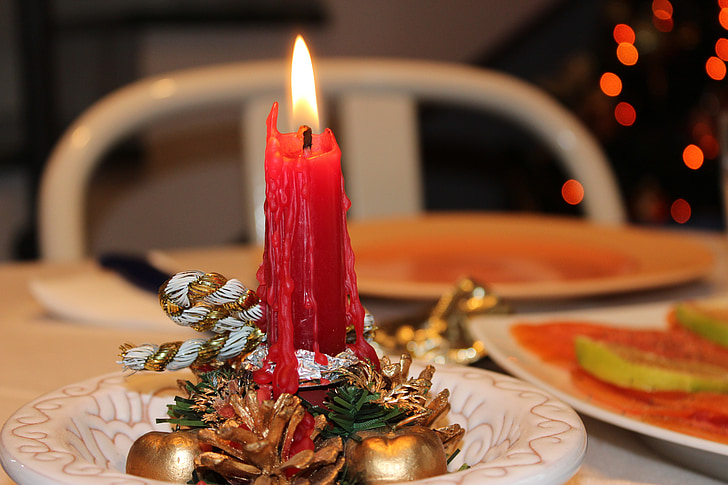 lighted red taper candle