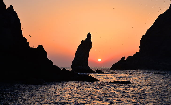 silhouette of islet rock