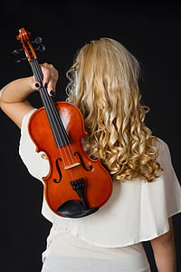 women with blonde hair holding violin