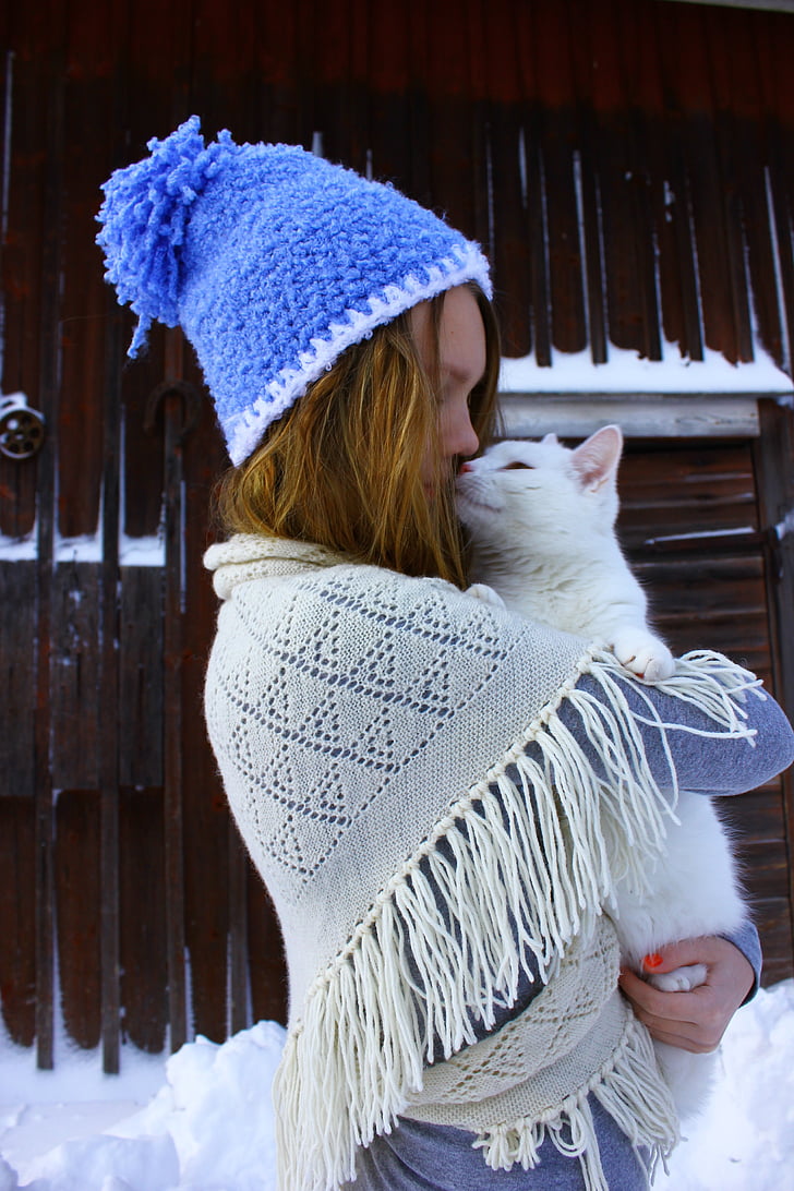 woman carrying white cat