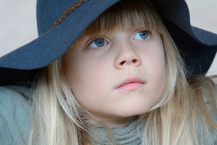 close up photo of girl wearing sun hat