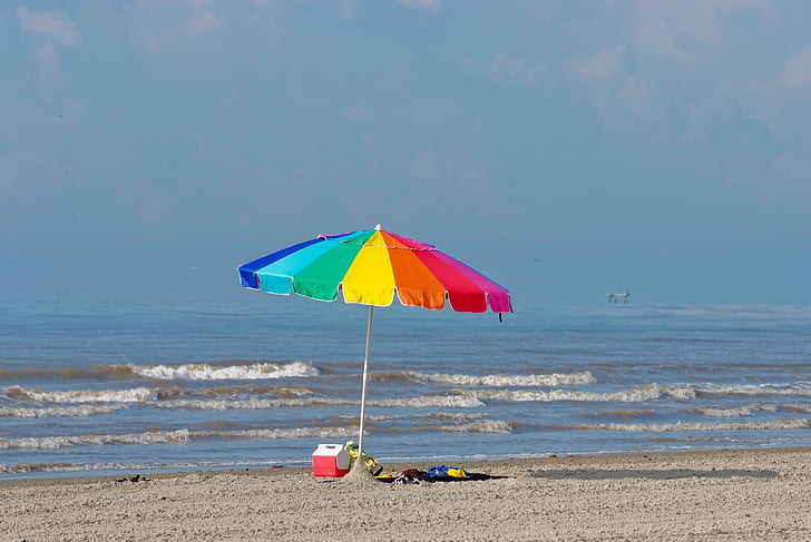 multicolored beach umbrella near beach