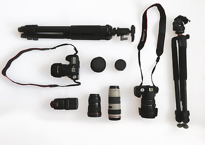 flat-lay photography of two DSLR cameras and tripods
