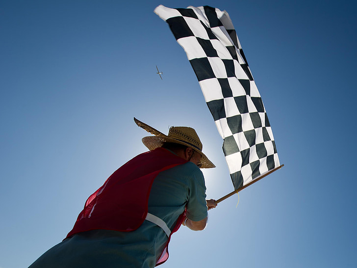 man carrying black and white checkered flag