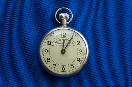 round silver-colored analog pocket watch
