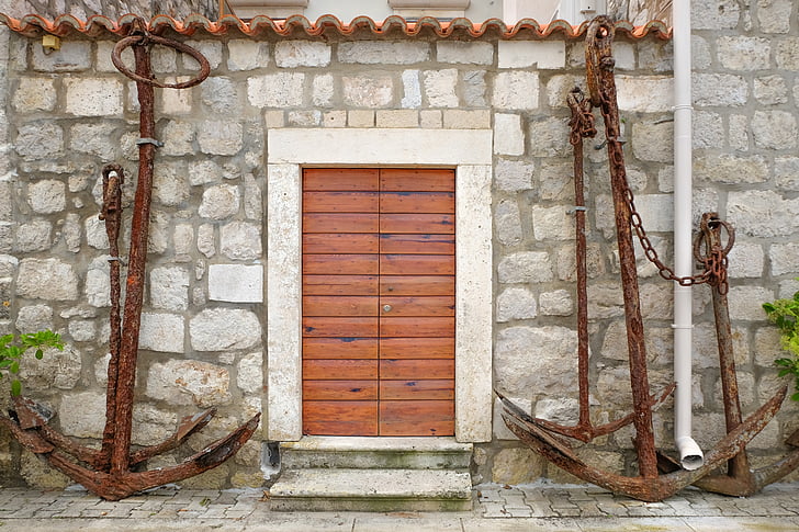 brown anchor near brown wooden door
