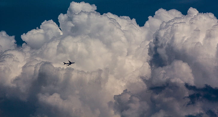gray plane on cloud