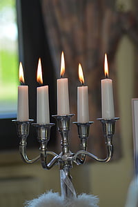gray metal candelabra with five lit candles