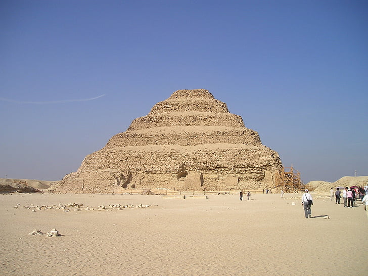 group of people walking beside pyramid during day time