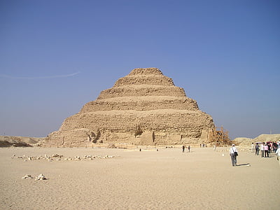 group of people walking beside pyramid during day time