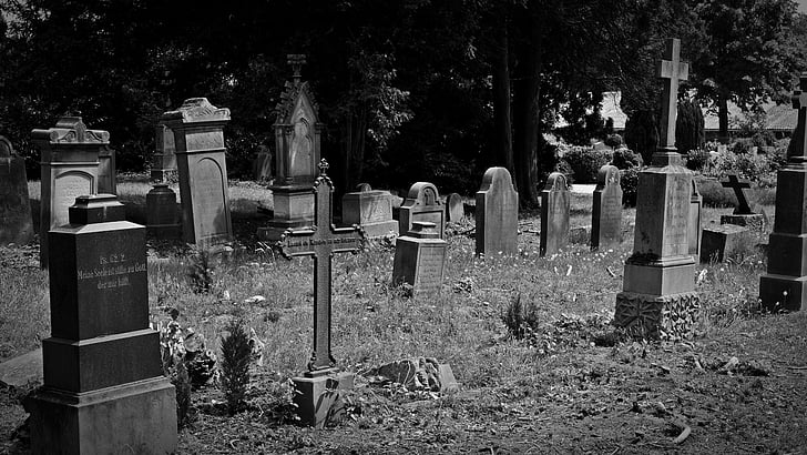 grayscale photo of graveyard during daytime