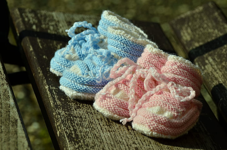 toddler's two pairs of teal and pink bootees