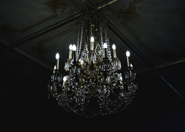 clear uplight chandelier on gray ceiling