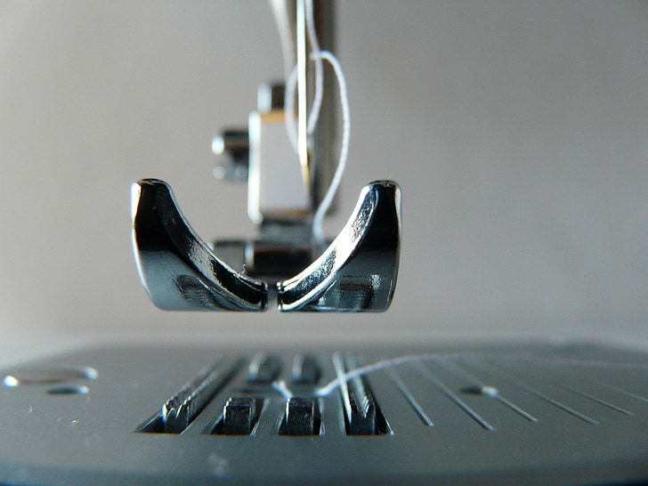 shallow focus photography of sewing machine part