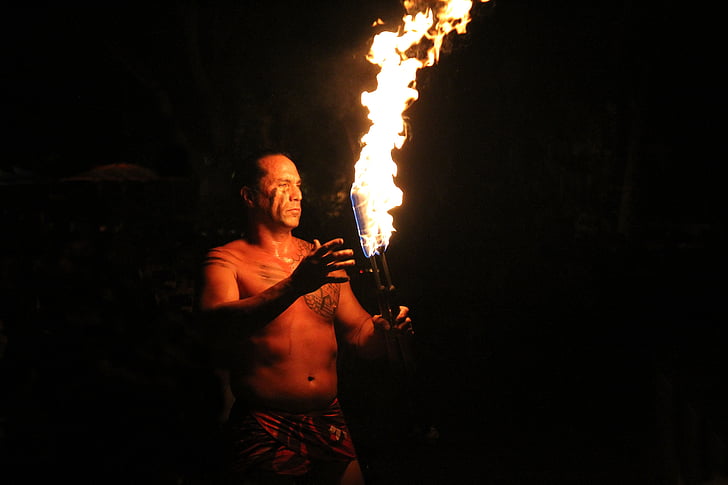 man holding torch with fire