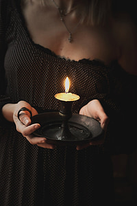 woman holding black oil lantern