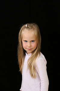 girl wearing white long-sleeved shirt with black background