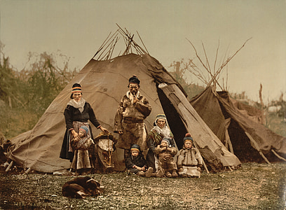 group of people and children standing near teetee tent