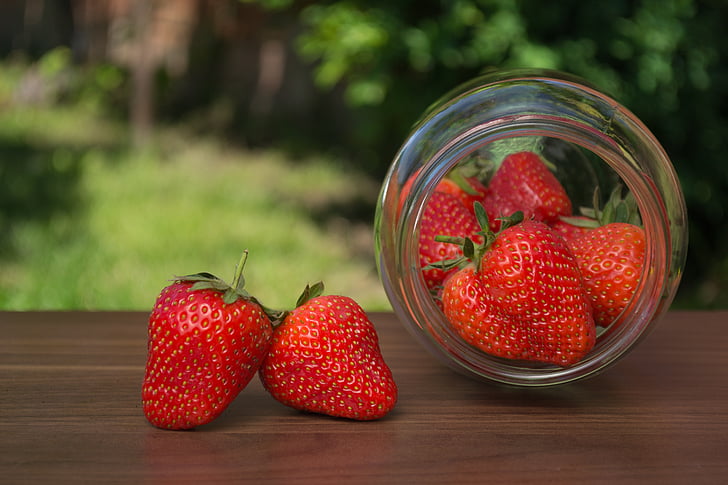 strawberries in clear glass jar