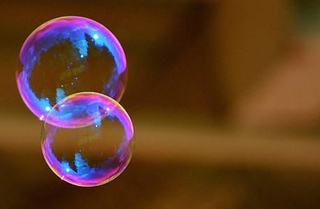 selective focus photography of two iridescent bubbles