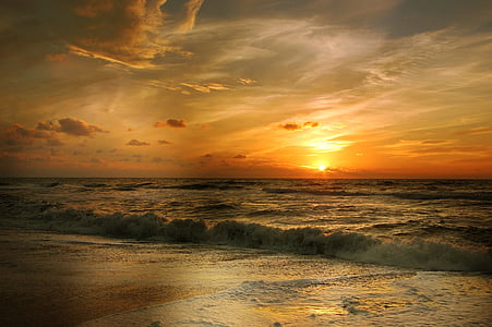 orange horizon with waves of ocean