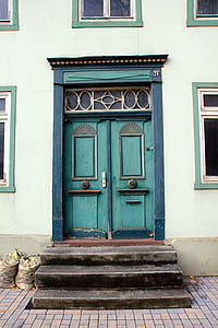 teal wooden closed door at daytime