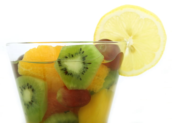 clear beverage glass filled with fruits