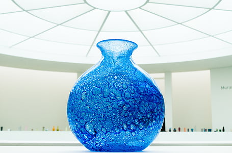 blue glass vase under glass ceiling