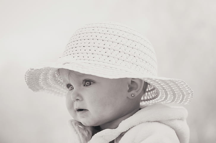 grayscale photo of baby wearing white knitted hat