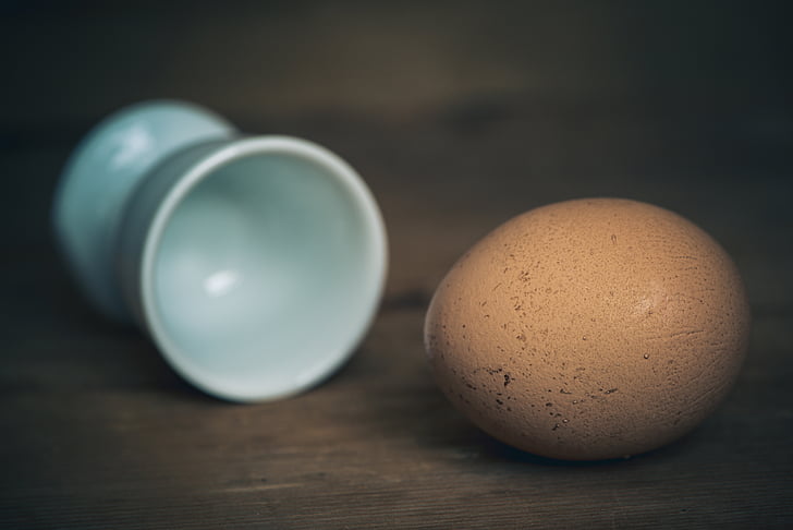 egg beside white egg holder