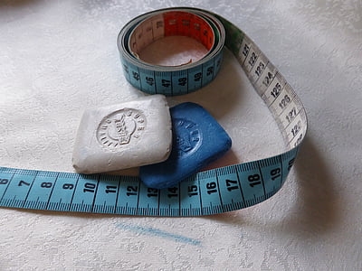 blue tape measure and two chalks