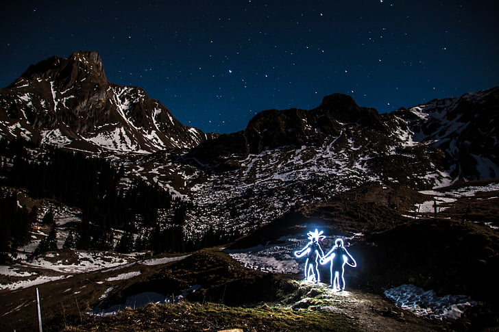 two human neon figures on mountain alps