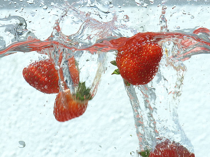 strawberry fruits dipped on water
