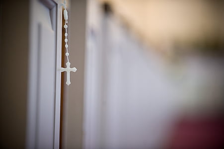 selective focus photography of white rosary