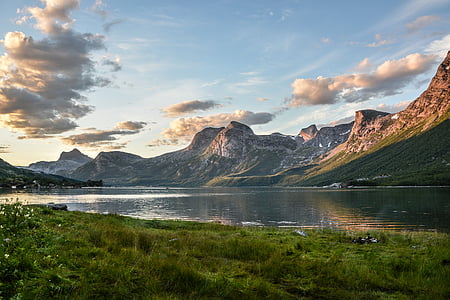 landscape photo of body of water near mountains
