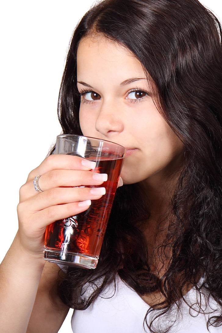 photo of woman about to drink a juice