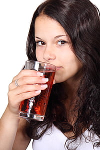 photo of woman about to drink a juice