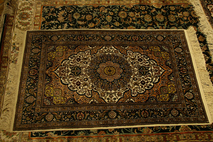two brown and black floral area rugs